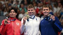 (L-R) Silver medallist Japan's Tomoyuki Matsushita, gold medallist France's Leon Marchand and bronze medallist US' Carson Foster pose