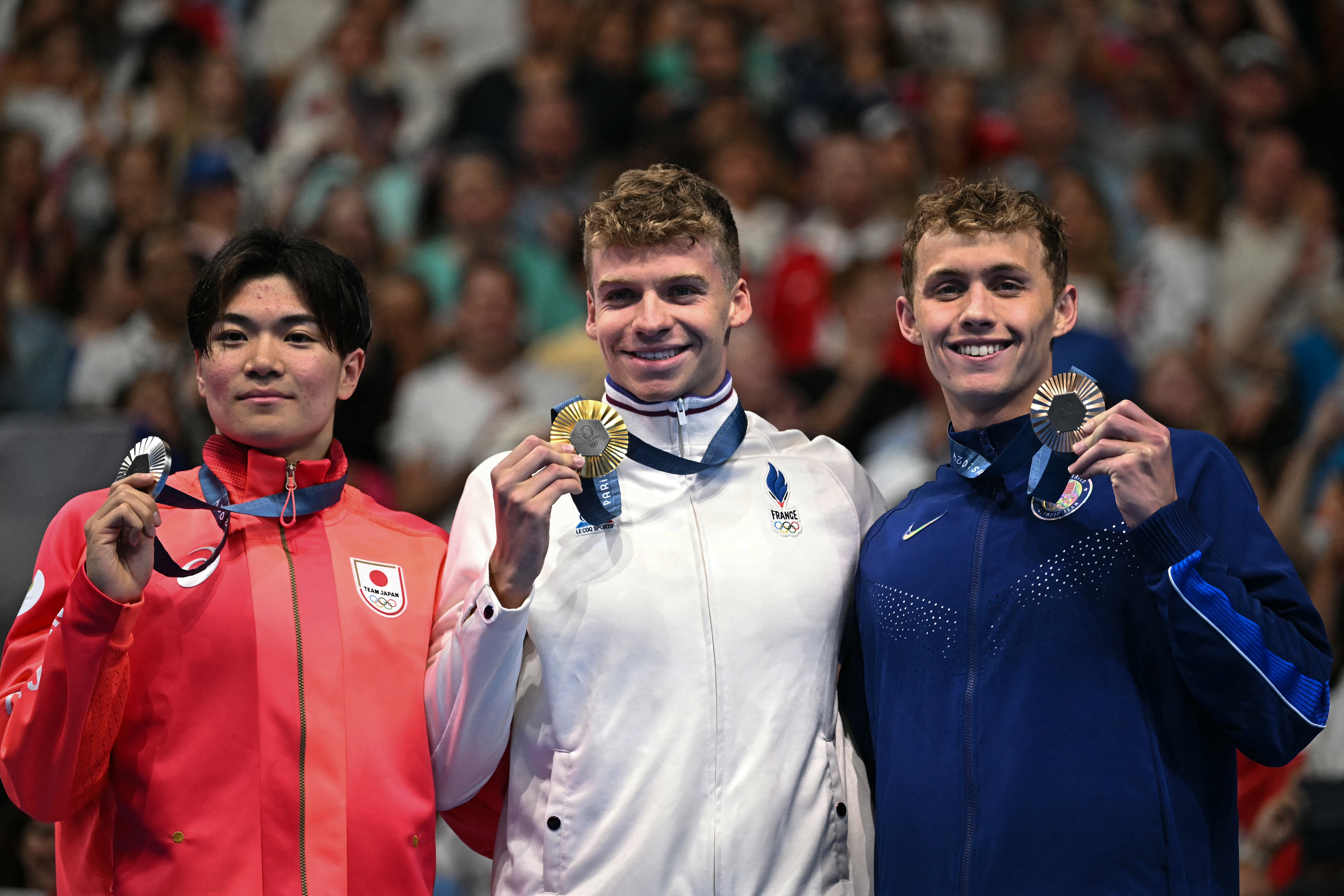 (L-R) Silver medallist Japan's Tomoyuki Matsushita, gold medallist France's Leon Marchand and bronze medallist US' Carson Foster pose