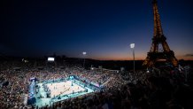 TOPSHOT - Spectators watch the women's pool C beach volleyball match between USA and Czech Republic during the Paris 2024 Olympic Games at the Eiffel Tower Stadium in Paris on July 28, 2024. (Photo by Luis TATO / AFP) (Photo by LUIS TATO/AFP via Getty Images)