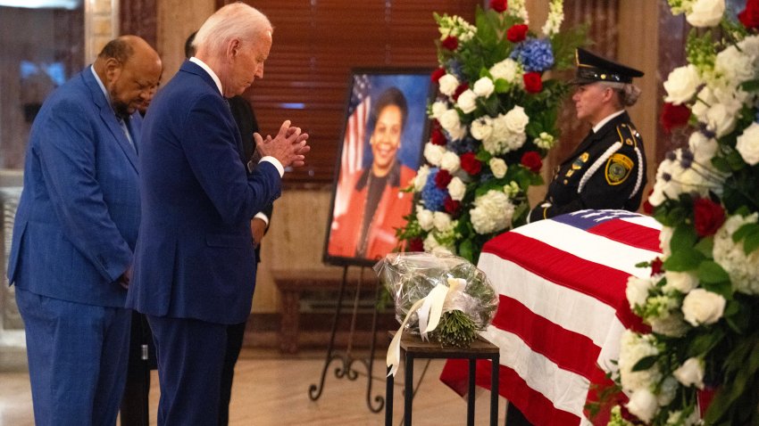 President Joe Biden prays by the flag-draped coffin of the late Congresswoman Sheila Jackson Lee, with her husband, Elwyn Lee, in the rotunda of Houston City Hall Monday, July 29, 2024, in Houston. Jackson Lee died on July 19 after battling pancreatic cancer.