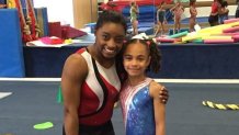 A young Hezly Rivera (right) poses for a picture with her idol Simone Biles (left) in a photo shared by Hezly's mother Heidy Ruiz.