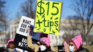 Activists demonstrate in support of a $15-per-hour minimum wage and tips for restaurant workers in Washington, D.C. on Feb. 8, 2022.