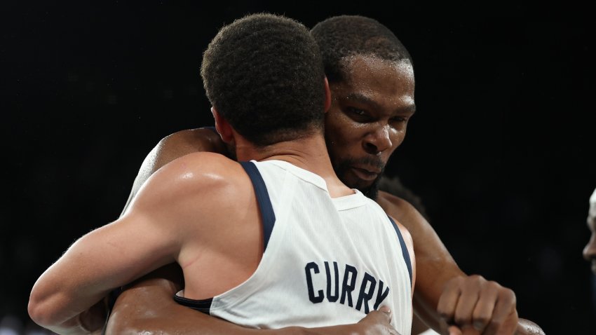 Kevin Durant hugs Stephen Curry