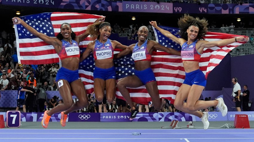 The United States’ women 4×400-meter relay team celebrates winning the gold medal at the 2024 Summer Olympics, Saturday, Aug. 10, 2024, in Saint-Denis, France.