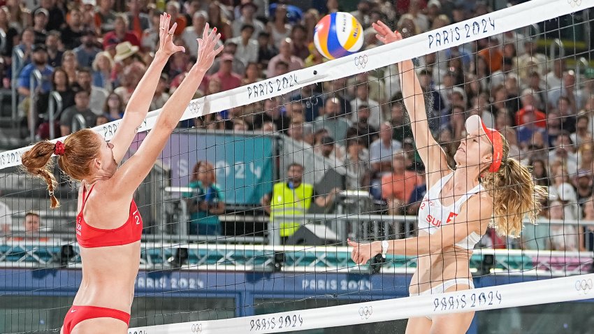 Kelly Cheng blocks in a beach volleyball match.