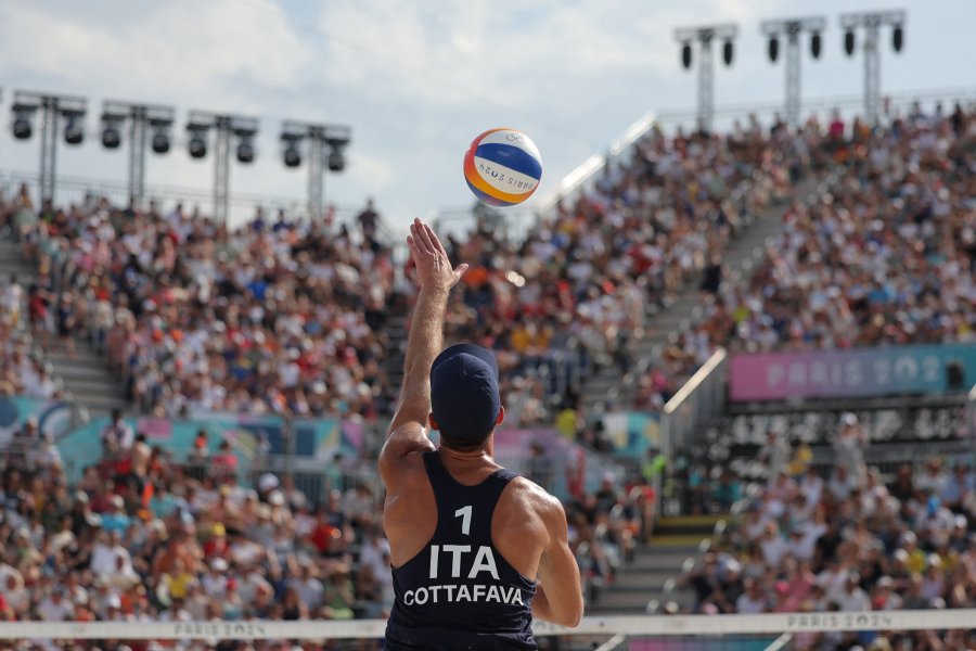 Italy's #01 Samuele Cottafava serves the ball in the men's pool A beach volleyball match