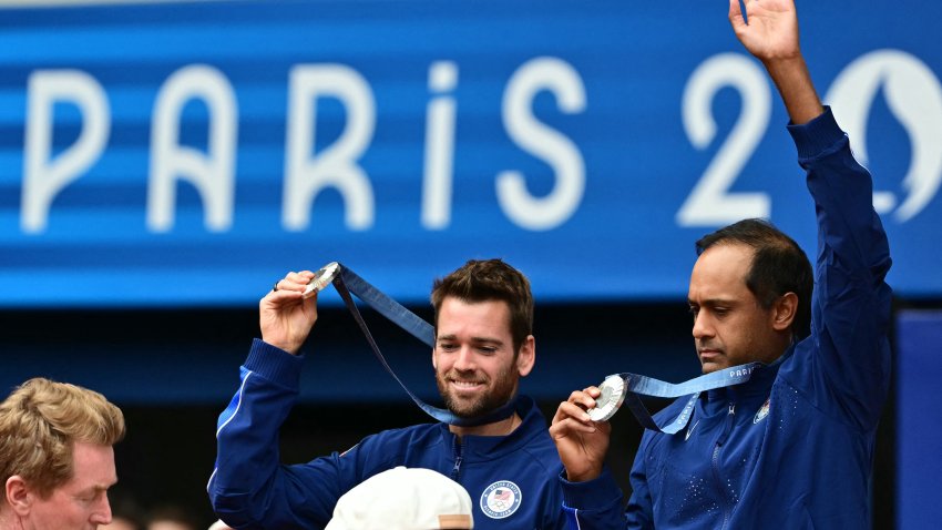 (L-R) Silver medallists, US’ Austin Krajicek and US’ Rajeev Ram pose with their medals on the podium at the presentation ceremony for the men’s doubles tennis event on Court Philippe-Chatrier at the Roland-Garros Stadium during the Paris 2024 Olympic Games, in Paris on August 3, 2024. (Photo by Miguel MEDINA / AFP) (Photo by MIGUEL MEDINA/AFP via Getty Images)