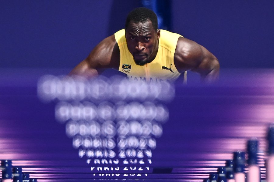 Jamaica's Hansle Parchment prepares to take the start in the men's 110m hurdles heat of the athletics event at the Paris 2024 Olympic Games at Stade de France in Saint-Denis, north of Paris, on August 4, 2024