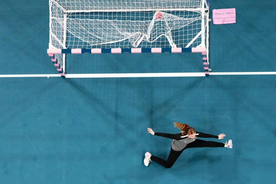 An overview shows Denmark's goalkeeper #16 Althea Reinhardt failing to save a goal during the women's quarter-final handball match between Denmark and The Netherlands of the Paris 2024 Olympic Games, at the Pierre-Mauroy stadium in Villeneuve-d'Ascq, northern France, on August 6, 2024