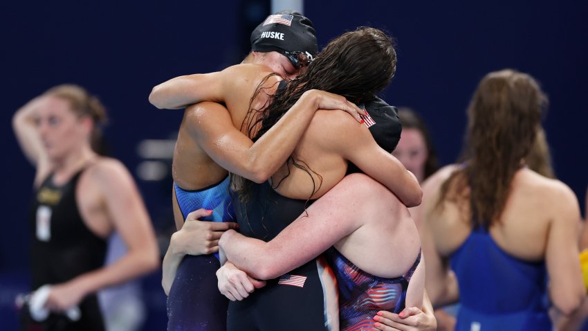 Torri Huske, Regan Smith, Lilly King hug after an Olympic gold medal win