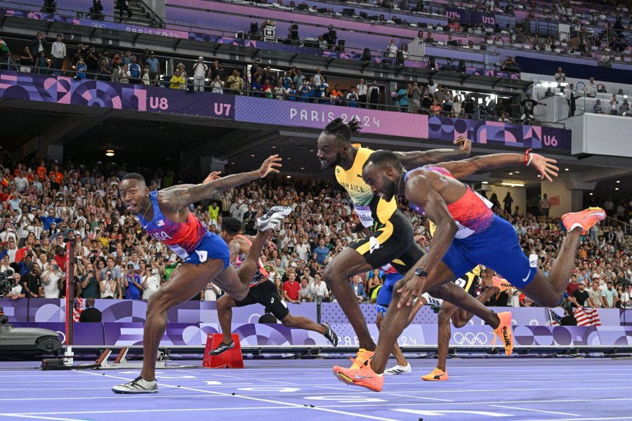 Grant Holloway crosses the finish line