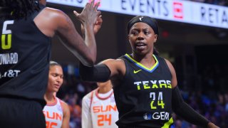 ARLINGTON, TX –  AUGUST 16: Arike Ogunbowale #24 of the Dallas Wings high fives during the game against the Connecticut Sun on August 16, 2024 at the College Park Center in Arlington, TX. NOTE TO USER: User expressly acknowledges and agrees that, by downloading and or using this photograph, User is consenting to the terms and conditions of the Getty Images License Agreement. Mandatory Copyright Notice: Copyright 2024 NBAE (Photo by Michael Gonzales/NBAE via Getty Images)