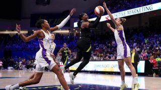 ARLINGTON, TEXAS – AUGUST 25: Arike Ogunbowale #24 of the Dallas Wings drives to the basket between Azura Stevens #23 and Stephanie Talbot #7 of the Los Angeles Sparks during the second half at College Park Center on August 25, 2024 in Arlington, Texas. NOTE TO USER: User expressly acknowledges and agrees that, by downloading and or using this photograph, User is consenting to the terms and conditions of the Getty Images License Agreement. (Photo by Sam Hodde/Getty Images)