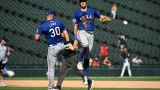 Aug 29, 2024; Chicago, Illinois, USA;  Texas Rangers first baseman Nathaniel Lowe (30) and third baseman Josh Jung (6) celebrate after the game against the Chicago White Sox at Guaranteed Rate Field. Mandatory Credit: Matt Marton-USA TODAY Sports