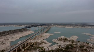 The U.S. 90 bridge crosses the Amistad Reservoir near Del Rio, Texas. Water deliveries from Mexico are stored at the reservoir, where water levels have dropped in recent months.