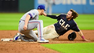 Aug 23, 2024; Cleveland, Ohio, USA; Cleveland Guardians third baseman Daniel Schneemann (10) steals second as Texas Rangers shortstop Corey Seager (5) makes the tag during the fifth inning at Progressive Field.