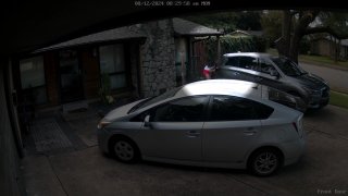 A girl (highlighted) hides behind a parked car after being spooked by a driver she said passed by her several times as she walked to her high school on Monday, Aug. 12, 2024.