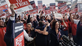 Julie Hedrick, president of the Association of Professional Flight Attendants, right, announces a strike authorization outside Dallas-Fort Worth International Airport near Dallas on Aug. 30, 2023.