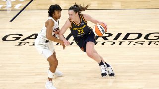 Indiana Fever guard Caitlin Clark, #22, drives to the basket against Atlanta Dream guard Destanni Henderson, #33, during a WNBA preseason game at Gainbridge Fieldhouse in Indianapolis, Indiana, on May 9, 2024.