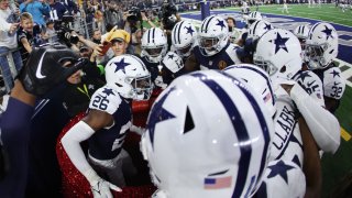 DaRon Bland, #26 of the Dallas Cowboys, celebrates after an interception returned for a touchdown in the game against the Washington Commanders during the fourth quarter at AT&T Stadium in Arlington, Texas, on Nov. 23, 2023.