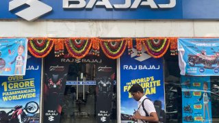 A man walks past a Bajaj motorcycle dealer shop, in Mumbai, India, 23 October, 2023. 