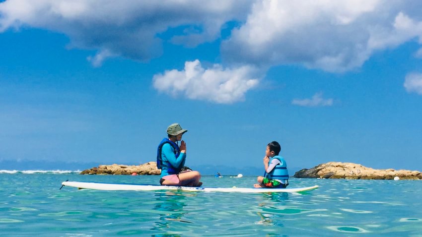 Dr. Jenny Woo and her son sharing a peaceful moment on a paddle board.