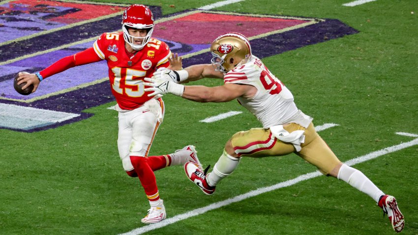 Quarterback Patrick Mahomes of the Kansas City Chiefs looks to throw under pressure from defensive end Nick Bosa of the San Francisco 49ers