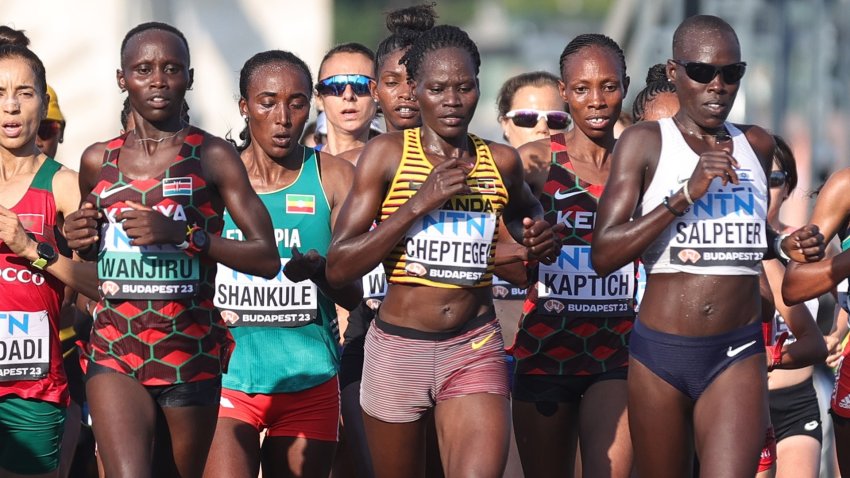 Ugandan Olympic athlete Rebecca Cheptegei running at the Paris Olympics with a crowd of other runners