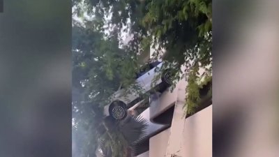 Woman rescued after car left dangling at Coral Gables parking garage