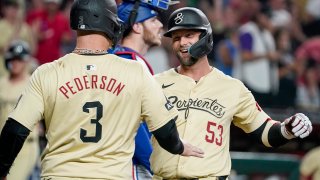 Arizona Diamondbacks’ Joc Pederson (3) greets Christian Walker, right, at home plate after Walker’s second home run of the game against the Texas Rangers during the third inning of a baseball game, Tuesday, Sept. 10, 2024, in Phoenix. (AP Photo/Darryl Webb)