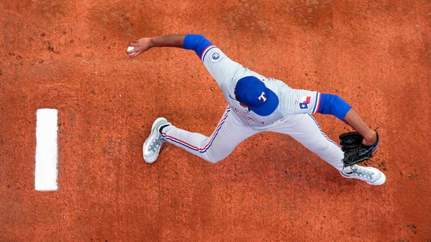 Texas Rangers starting pitcher Kumar Rocker warms up before his major league debut against the Seattle Mariners in a baseball game Thursday, Sept. 12, 2024, in Seattle. (AP Photo/Lindsey Wasson)