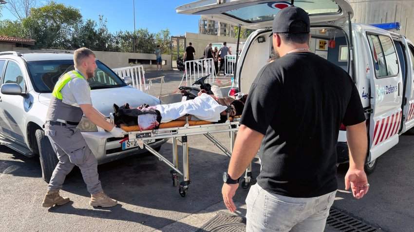 Civil Defense first-responders carry a wounded man whose handheld pager exploded at al-Zahraa hospital in Beirut, Lebanon, Tuesday, Sept. 17, 2024.