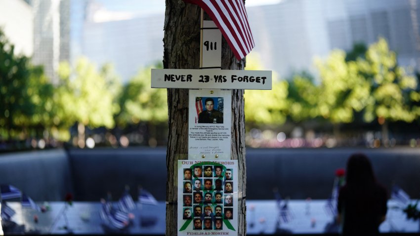 People look at the 9/11 memorial on the 23rd anniversary of the September 11 terror attack on the World Trade Center at Ground Zero, in New York City on September 11, 2024. (Photo by Adam GRAY / AFP) (Photo by ADAM GRAY/AFP via Getty Images)