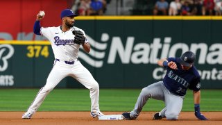 ARLINGTON, TEXAS – SEPTEMBER 21: Marcus Semien #2 of the Texas Rangers forces out Cal Raleigh #29 of the Seattle Mariners at second base in the first inning at Globe Life Field on September 21, 2024 in Arlington, Texas. (Photo by Richard Rodriguez/Getty Images)