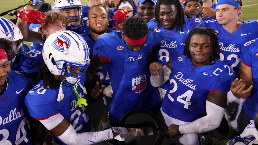 DALLAS, TEXAS – SEPTEMBER 21: Southern Methodist Mustangs players celebrate with the Iron Skillet trophy after defeating TCU Horned Frogs at Gerald J. Ford Stadium on September 21, 2024 in Dallas, Texas. (Photo by Sam Hodde/Getty Images)