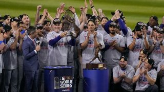 FILE – Texas Rangers manager Bruce Bochy holds up the trophy after Game 5 of the baseball World Series against the Arizona Diamondbacks Wednesday, Nov. 1, 2023, in Phoenix. (AP Photo/Gregory Bull, file)