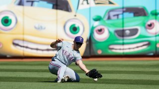 Texas Rangers left fielder Wyatt Langford is unable to catch a single hit by Oakland Athletics’ Jacob Wilson during the fifth inning of a baseball game Thursday, Sept. 26, 2024, in Oakland, Calif. Wilson advanced to second on the fielding error by Langford. (AP Photo/Godofredo A. Vásquez)