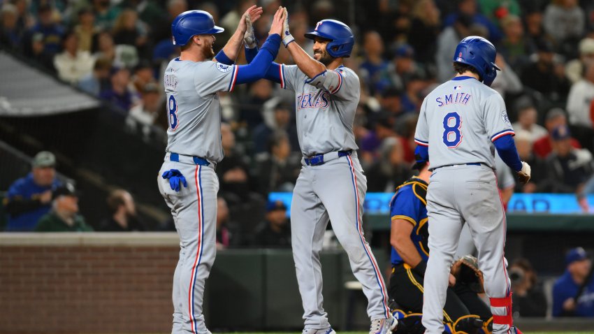 Sep 14, 2024; Seattle, Washington, USA; Texas Rangers catcher Carson Kelly (18) and second baseman Marcus Semien (2) celebrate after Semien hit a 2-run home run against the Seattle Mariners during the fifth inning at T-Mobile Park. Mandatory Credit: Steven Bisig-Imagn Images