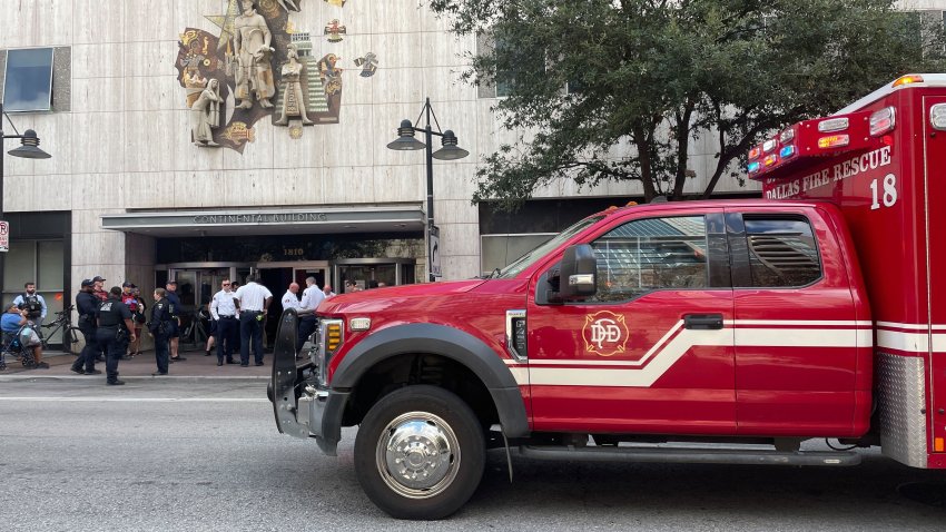 Dallas police and fire officials outside the Mercantile Building, Sept. 12, 2024.