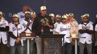 Texas Rangers GM, center in black, speaks at a World Series Championship parade in Arlington, Texas on Nov. 3, 2023.