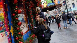 People look at the holiday window displays at a Macy’s store in Herald Square on December 11, 2023 in New York City.