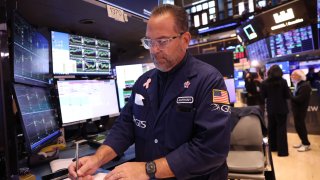 Traders work on the floor of the New York Stock Exchange during morning trading in New York City. 