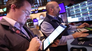 Traders work on the floor of the New York Stock Exchange during morning trading in New York City.