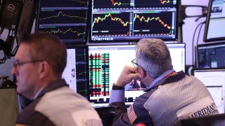Traders work on the floor of the New York Stock Exchange during morning trading in New York City.