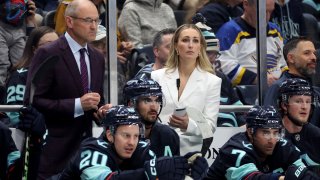 Head coach Dan Bylsma and assistant coach Jessica Campbell of the Seattle Kraken look on during the first period against the St. Louis Blues at Climate Pledge Arena on October 08, 2024 in Seattle, Washington. Campbell is the first woman to coach in the NHL.