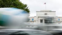 Cars drive past the Federal Reserve building on September 17, 2024 in Washington, DC.