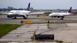 A United Airlines and Delta Airlines passenger jet taxi at LaGuardia Airport in New York, New York. 