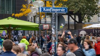 Passers-by walk in the pedestrian zone of the Bavarian capital.