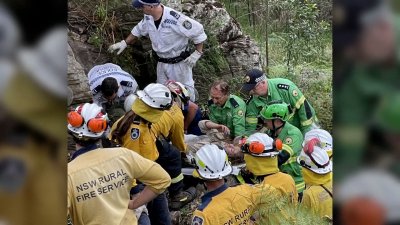 Woman rescued after spending hours hanging upside-down between boulders