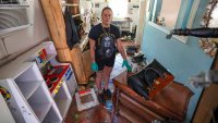 Amanda Normand cleans up the home of Aiden Bowles who died in the home during flooding from Hurricane Helene on Wednesday, Oct. 2, 2024, in Indian Rocks Beach, Fla.